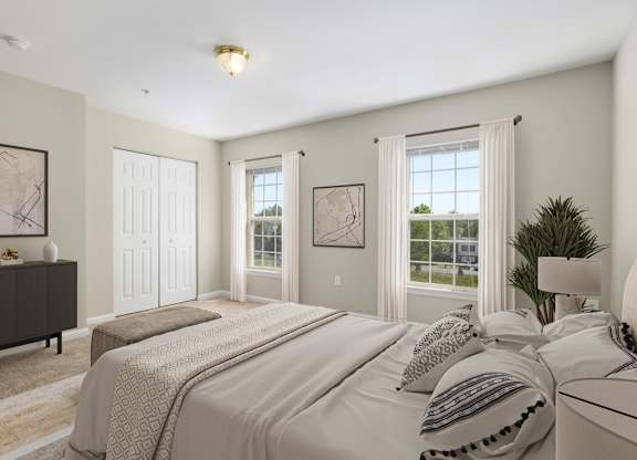 A bedroom with a large bed and a dresser.